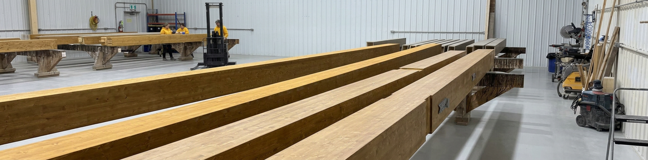 Tarvudd Construction crew fabricating large timber beams in the shop